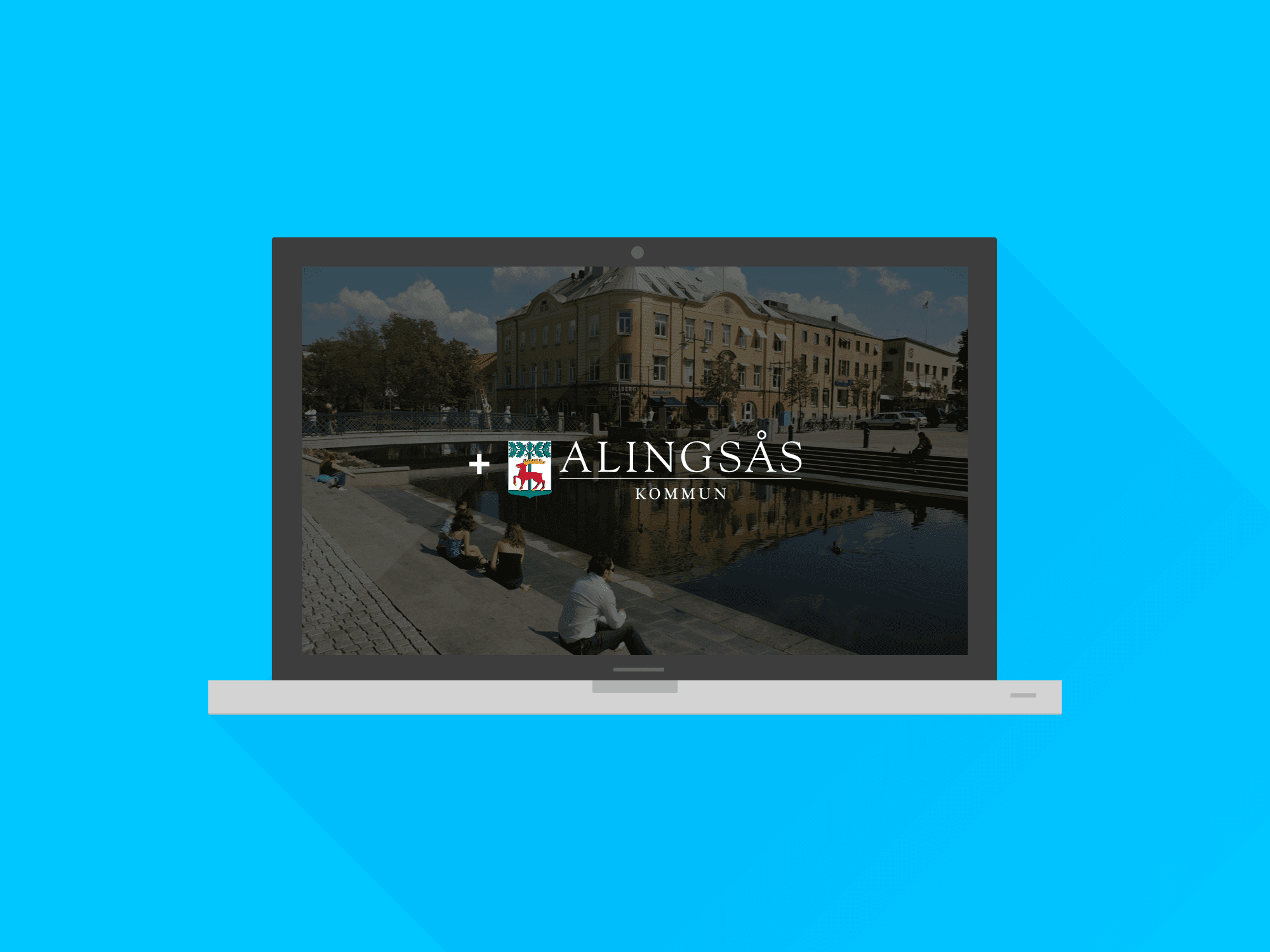 Illustration av en dator med Alingsås kommunvapen på skärmen